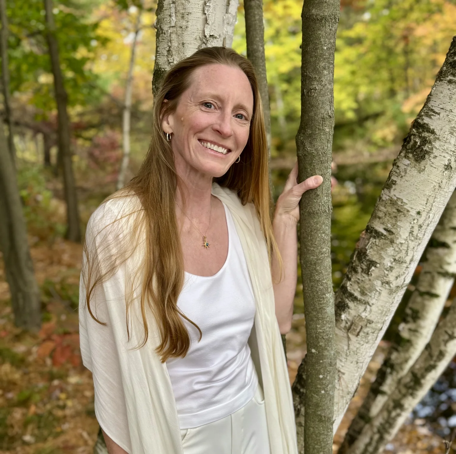 Alissa Sunshine standing among birch trees
